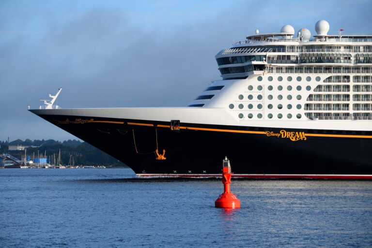 Disney Cruise Line ship bow view at sea, representing early cruise vacation booking